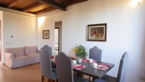 a living room with a table and a couch at Capalbio - Retreat in Capalbio