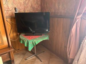 a computer monitor sitting on a table in a room at Golden Rose Apartman in Zánka