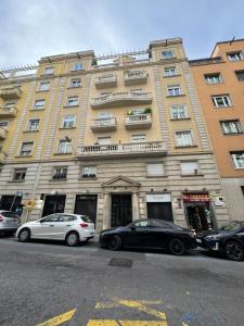 two cars parked in front of a large building at Pensión Laforja in Barcelona