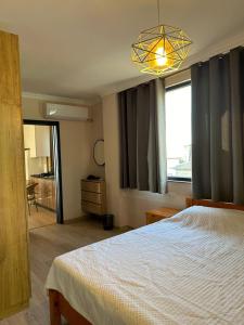 a bedroom with a bed and a chandelier at Magnet House in Ureki +35 photos