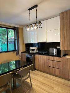 a kitchen with a table and a dining room at Magnet House in Ureki