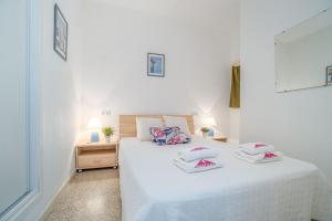 una camera da letto con un letto bianco con due cuscini sopra di Basic Comfort Apartment Royal Marine 0176 a Empuriabrava