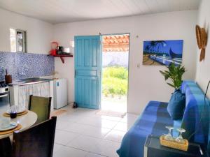阿拉卡蒂的住宿－Casinha Estrela do Mar o Oceano aos seus Pés，厨房以及带蓝色门的起居室。