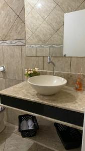 a bathroom with a white sink and a mirror at Casa de Maria in Aparecida +30 photos