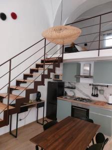 a kitchen and dining room with a spiral staircase at Dimora Apulia 5 in Gallipoli