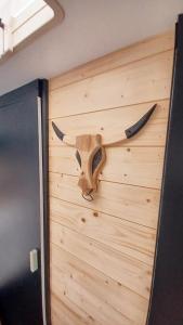 a wooden door with a bull head on it at La Cour d'Hortense in Sailly-Flibeaucourt