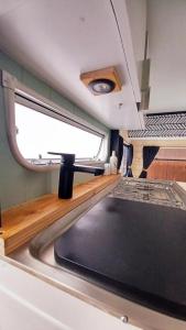 a kitchen with a sink and a window at La Cour d'Hortense in Sailly-Flibeaucourt