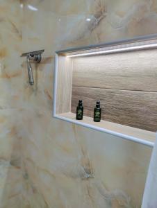 a bathroom with two soap bottles on a mirror at Infinity Apartment in Nea Moudania