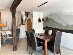 a dining room with a wooden table and chairs at Ferienhaus Andrea mit Whirlpool und Sauna in Rimsting