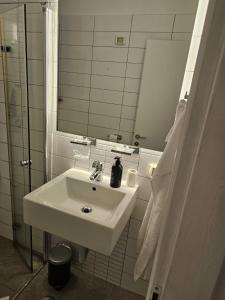 a bathroom with a white sink and a mirror at Hayarkon Superior TLV Beach 7B in Tel Aviv