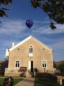 a purple balloon is flying over a building at Albergue e AL O Brasão Valença in Valença