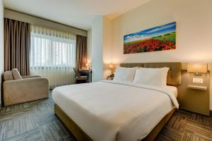 Ένα ή περισσότερα κρεβάτια σε δωμάτιο στο Plus Hotel Bostanci Atasehir