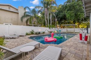 a swimming pool with a pink swan in the middle at Pickleball~ Pool~ Game Room~ 5 min to Beach in Seminole