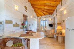 a living room with a table and a refrigerator at Paco's Resort Luxury Villa 19 in Oziás