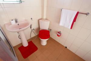 a small bathroom with a toilet and a sink at RedHill Kandy in Kandy