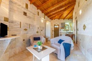 a living room with two chairs and a table at Paco's Resort Luxury Villa 18 in Oziás