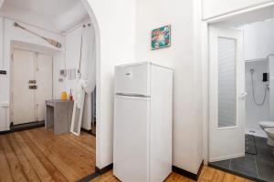 a white refrigerator in a room with a bathroom at Apartment baia del silenzio beach in Sestri Levante +16 photos