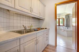 a kitchen with a sink and a tub at Pension Bergblick in Marienberg +126 photos