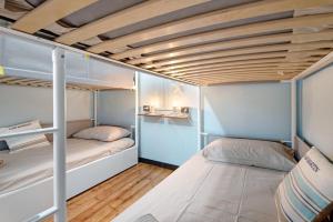 two bunk beds in a small room with wooden floors at Apartment baia del silenzio beach in Sestri Levante