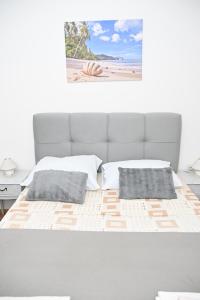 Postel nebo postele na pokoji v ubytování APARTMENTS ANDREA