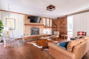 a living room with a couch and a fireplace at Serene Catskills Retreat with Deck in Woodbourne
