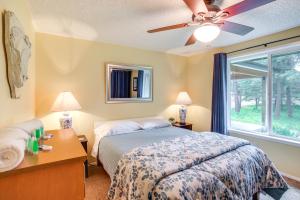 a bedroom with a bed and a window at 10 Mi to Silverwood Secluded Getaway! in Spirit Lake