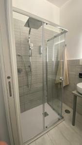 a shower with a glass door in a bathroom at Golden Mile B&B in Ercolano