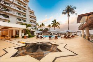 a resort with a swimming pool and a building at Villa Premiere Boutique Hotel & Romantic Getaway - Adults Only in Puerto Vallarta