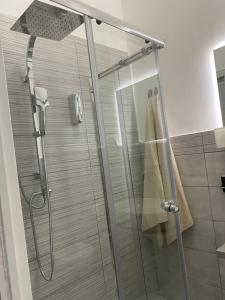 a shower with a glass door in a bathroom at Golden Mile B&B in Ercolano