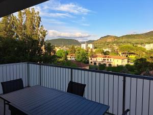 a table on a balcony with a view of a city at Malnati home in Terni