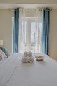 a pile of towels sitting on top of a bed at 2 BR 5 pax Spacious Elegant Condo in Saint Dominique, Megaworld, Iloilo City in Iloilo City