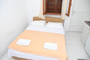 Postel nebo postele na pokoji v ubytování APARTMENTS ANDREA