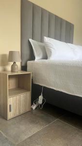 1 dormitorio con 1 cama con lámpara y mesita de noche en Stylish Self Catering Unit in Maseru CBD, en Maseru