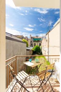 a patio with a table and chairs on a balcony at Modern Studio della Valle x2 in Padova