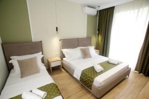Postel nebo postele na pokoji v ubytování Hotel Villa ATA + 37 fotografií