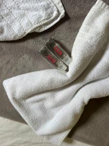 a close up of a bottle on a white towel at CLH Suites Ilha Grande in Abraão