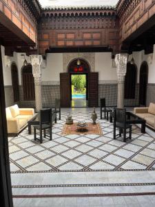 a large room with a lobby with chairs and a table at Riad Tazi Casablanca in Casablanca