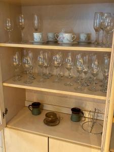 a bunch of wine glasses sitting on a shelf at Villa Siikakoski in Konnevesi
