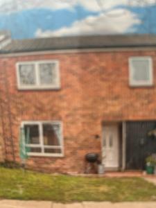 a brick house with a window and a door at DK House in Colchester