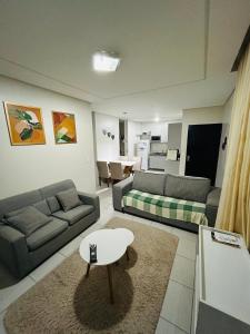 a living room with two couches and a coffee table at Apartamento Caruaru PE bairro Mauricio de Nassau in Caruaru