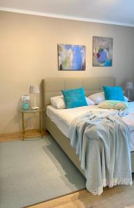 a bedroom with a large bed with blue pillows at "Ellas Home Sekirn" - in 3min am Badestrand in Sekirn +16 photos