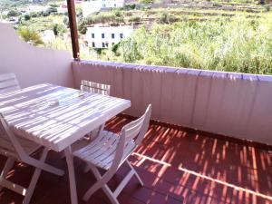a table and chairs on the balcony of a house at L'Isolana Case Vacanza Alloro 1 in Ponza