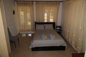 a bedroom with a bed with two pillows on it at Demar Rooms & Apartments in Katakolon