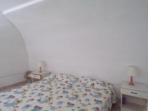a bedroom with a bed and two night stands at L'Isolana Case Vacanza Alloro 1 in Ponza
