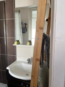 a bathroom with a sink and a mirror at Hôtel Eden - La Baigneuse in Juan-les-Pins