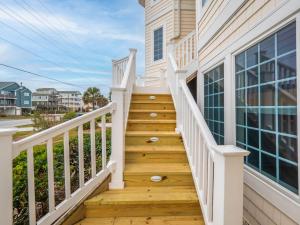 a staircase leading to a home with white railings at Coppertop in North Topsail Beach