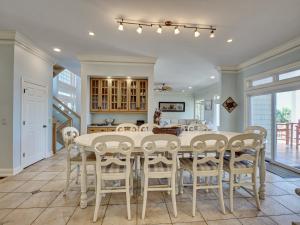 a kitchen and dining room with a table and chairs at Coppertop in North Topsail Beach