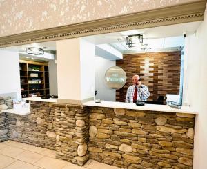 a man standing behind a stone counter in a restaurant at The Walden, Trademark Collection By Wyndham in Pigeon Forge