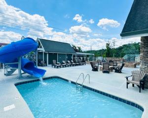 a swimming pool with a slide in the middle at The Walden, Trademark Collection By Wyndham in Pigeon Forge