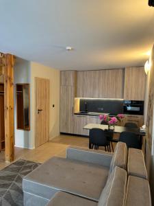 a living room with a couch and a table at Vila Vika in Palanga